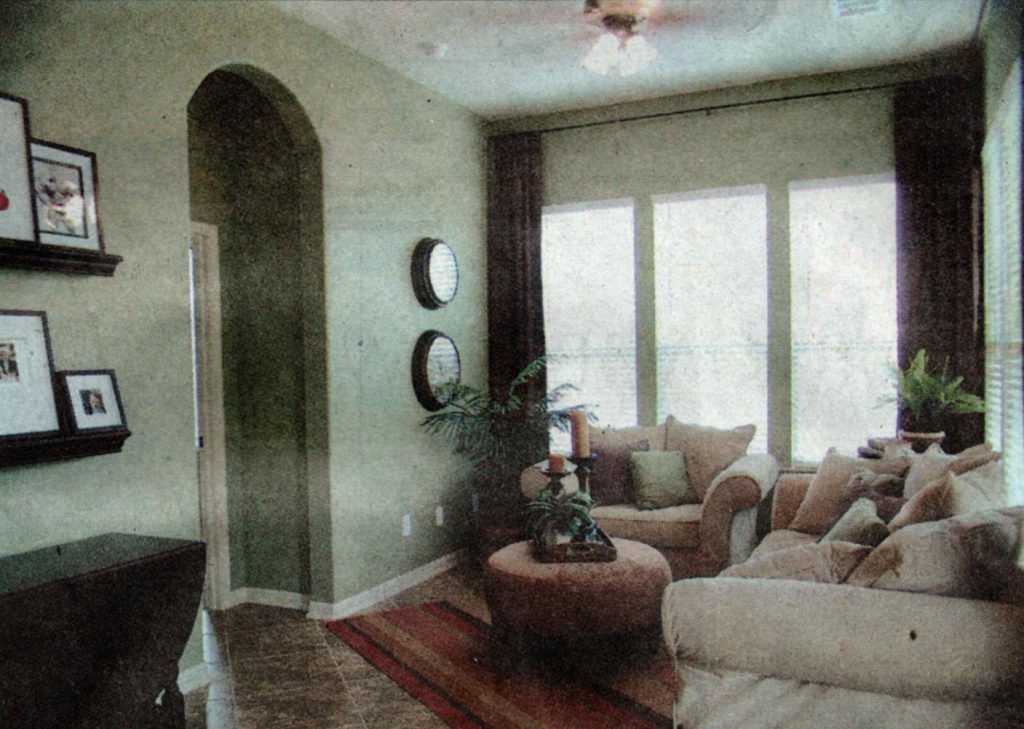 A living room with two windows and a couch
